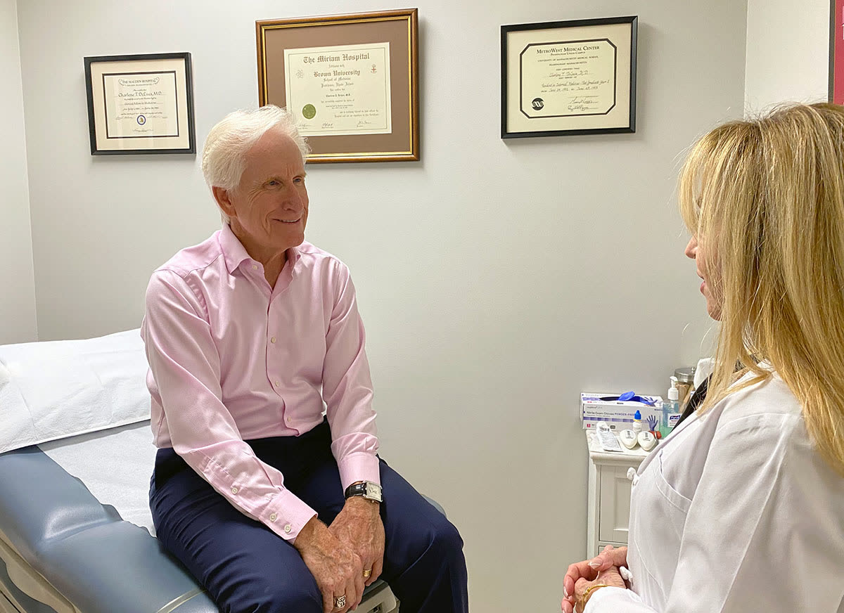 Dr. DeLuca in a consultation with a patient in the exam room
