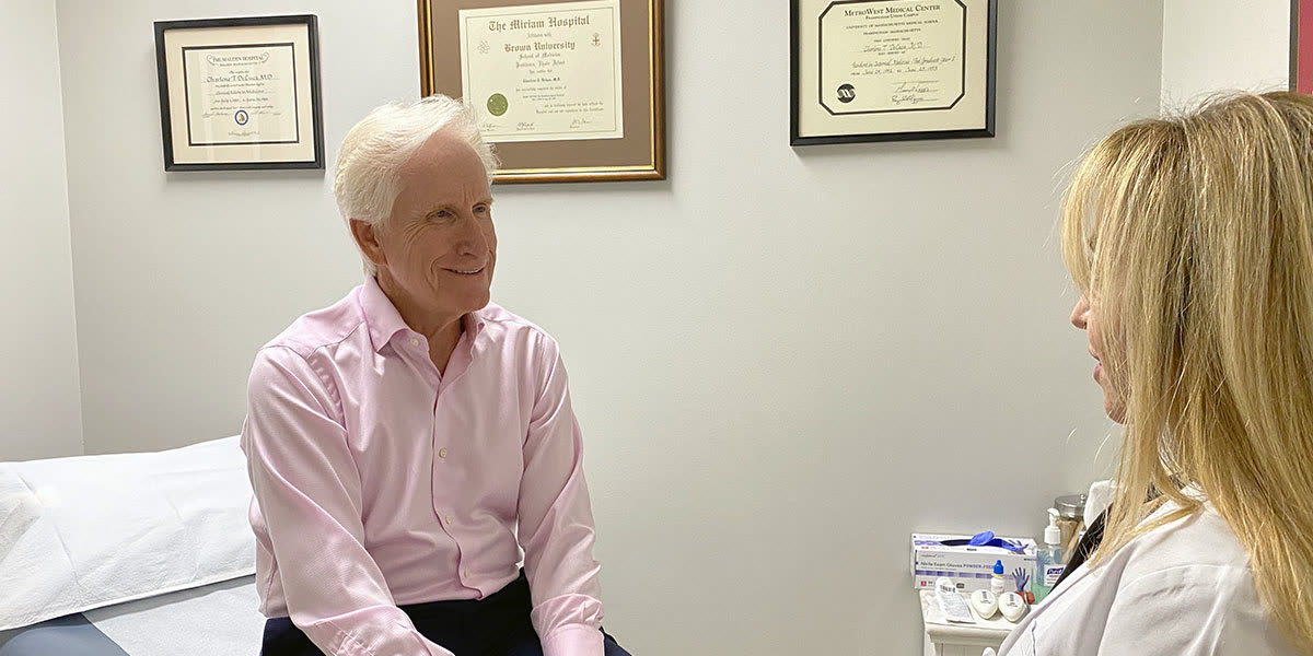 Dr. DeLuca speaking with a patient in the exam room