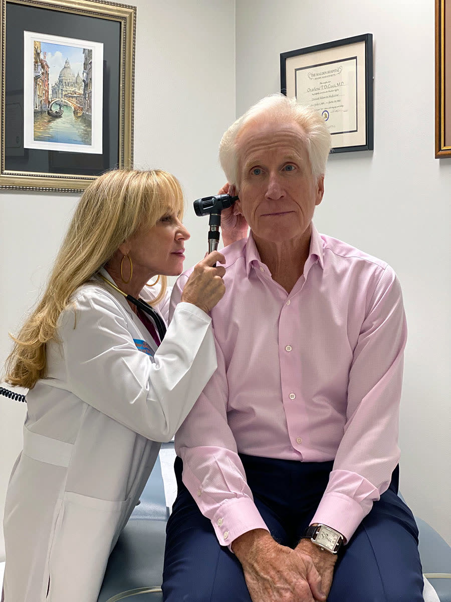 Dr. DeLuca examining a patient at her Naples office